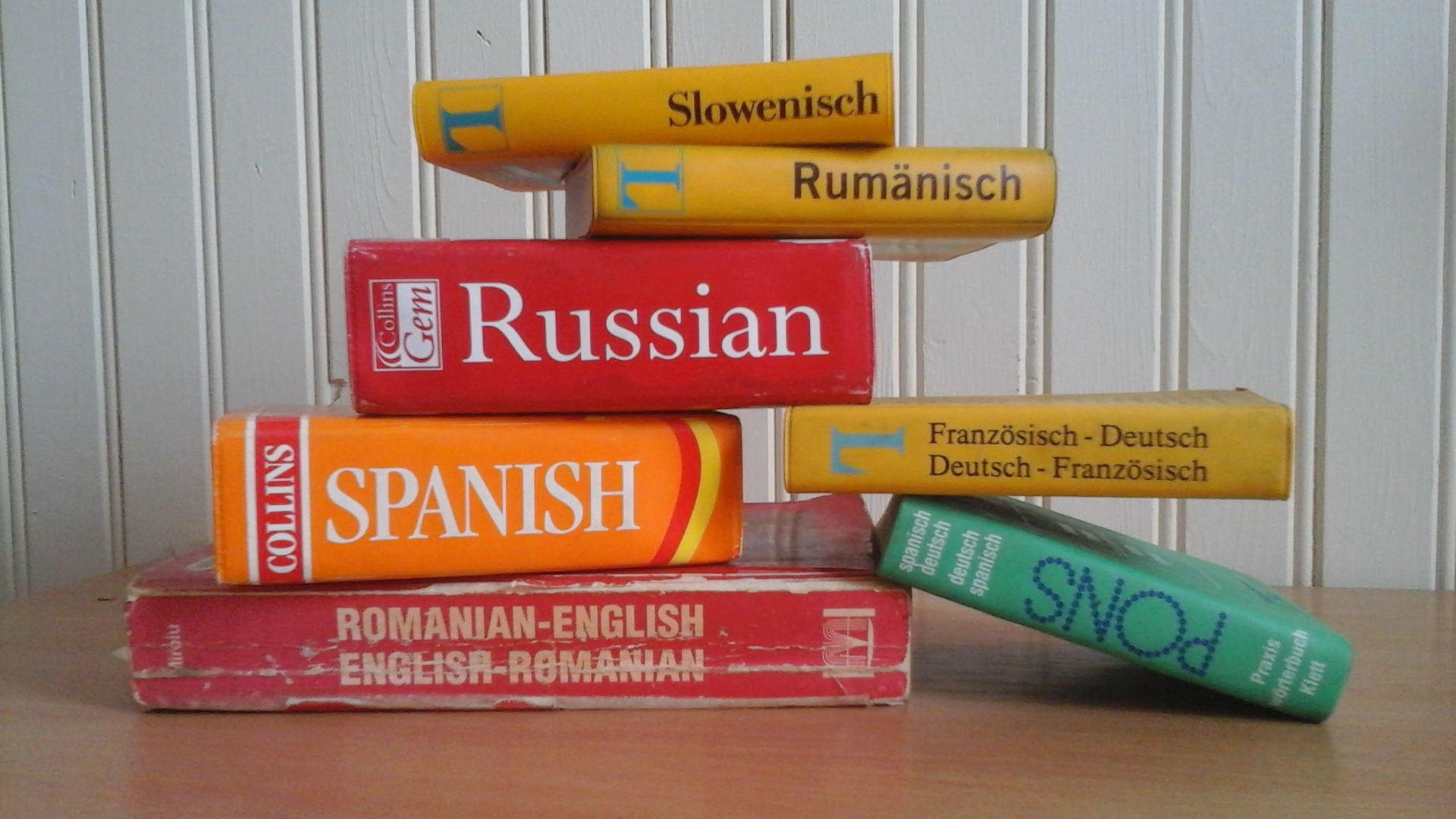 Dictionaries in several languages are piled up on top of each other